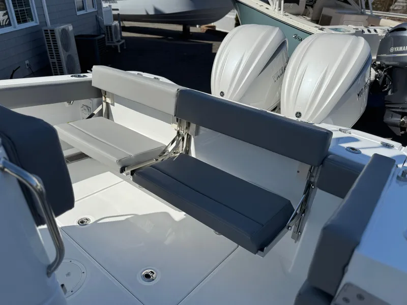 Slide: The Image of 2025 Everglades 285 Center Console boat with dual outboard engines and gray seating. - 22