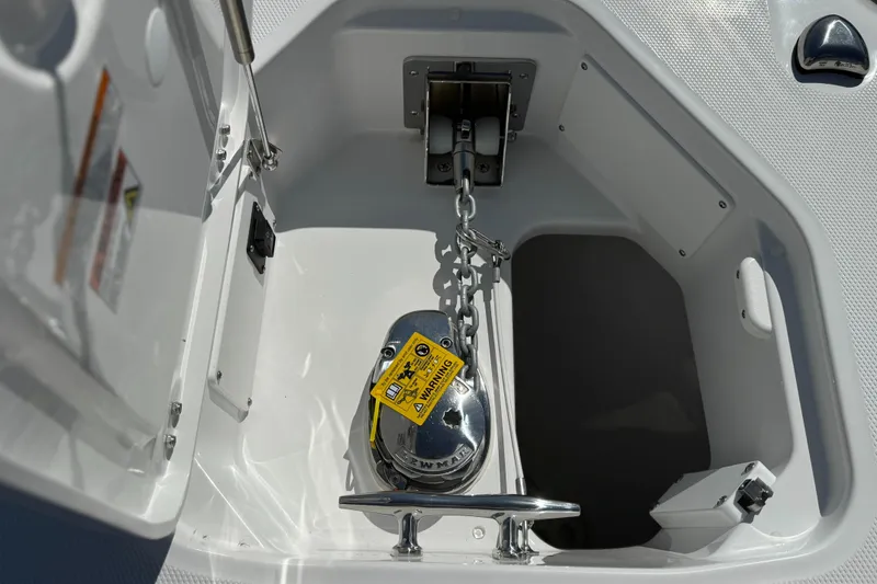 Slide: The Image of Anchor compartment of 2025 Everglades 285 Center Console boat, featuring chain and winch. - 26