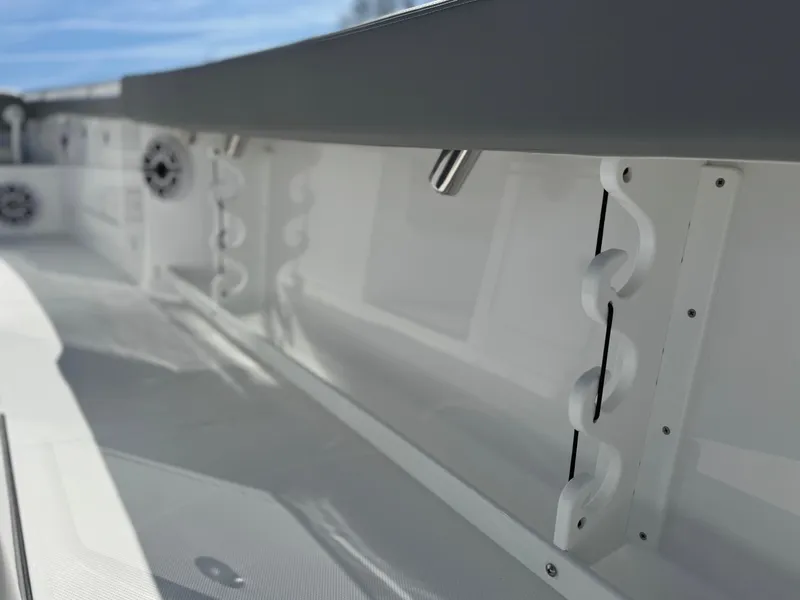 Slide: The Image of 2025 Everglades 285 Center Console boat interior with rod holders and speakers. - 29