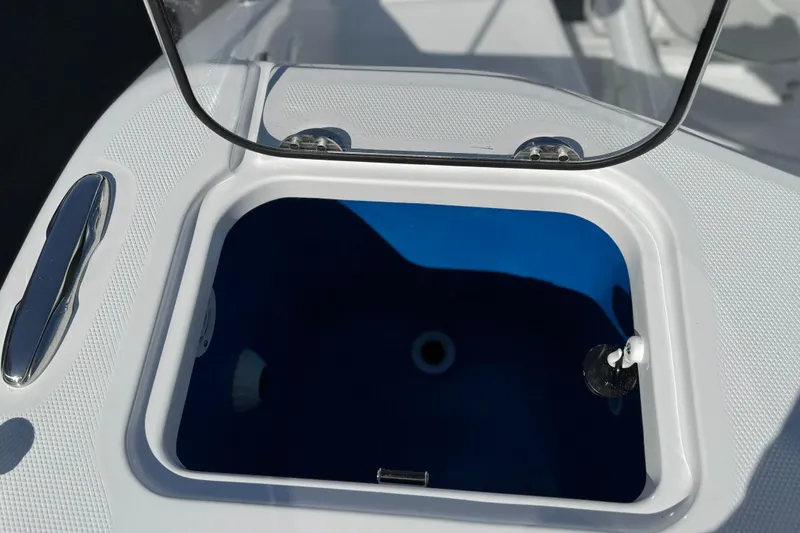Slide: The Image of Livewell on 2025 Everglades 285 Center Console boat, open lid, white and blue interior. - 31