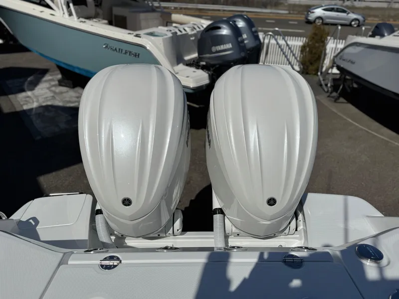 Slide: The Image of Twin outboard engines on a 2025 Everglades 285 Center Console boat, parked in a marina. - 34