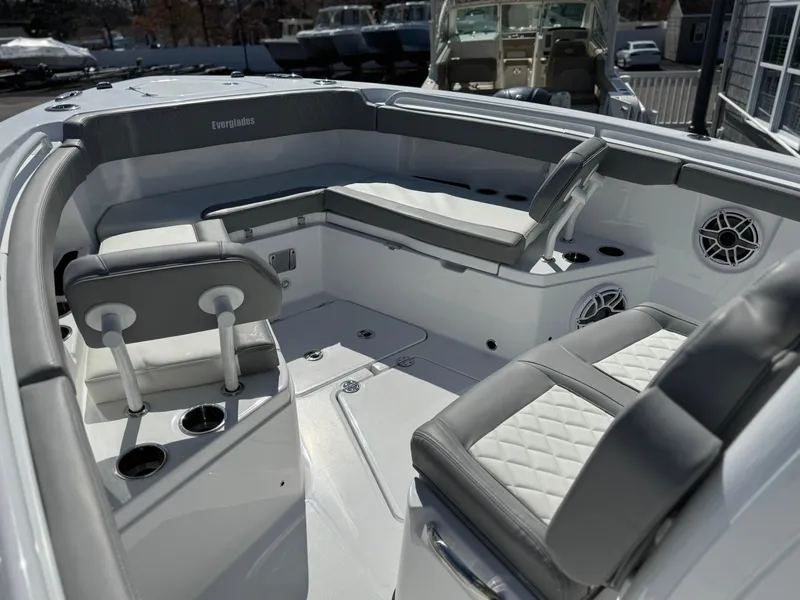 Slide: The Image of 2025 Everglades 285 Center Console boat interior with cushioned seating and cup holders. - 6