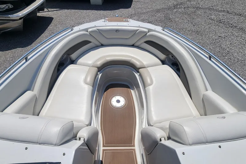 Slide: The Image of 2008 Crownline 240LS boat interior with white seating and wood accents. - 11