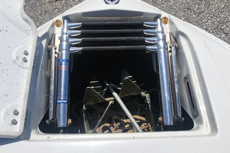Slide: The Image of Anchor storage compartment on a 2008 Crownline 240LS boat, featuring a ladder and ropes. - 14