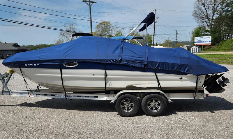 Slide: The Image of 2008 Crownline 240LS boat on trailer, covered with blue tarp, parked outdoors. - 17