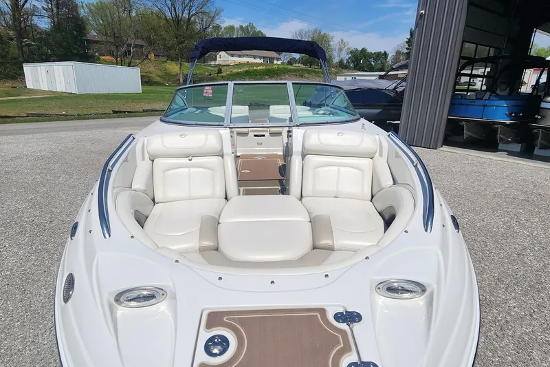Slide: The Image of 2008 Crownline 240LS boat with white seating and open bow design. - 2