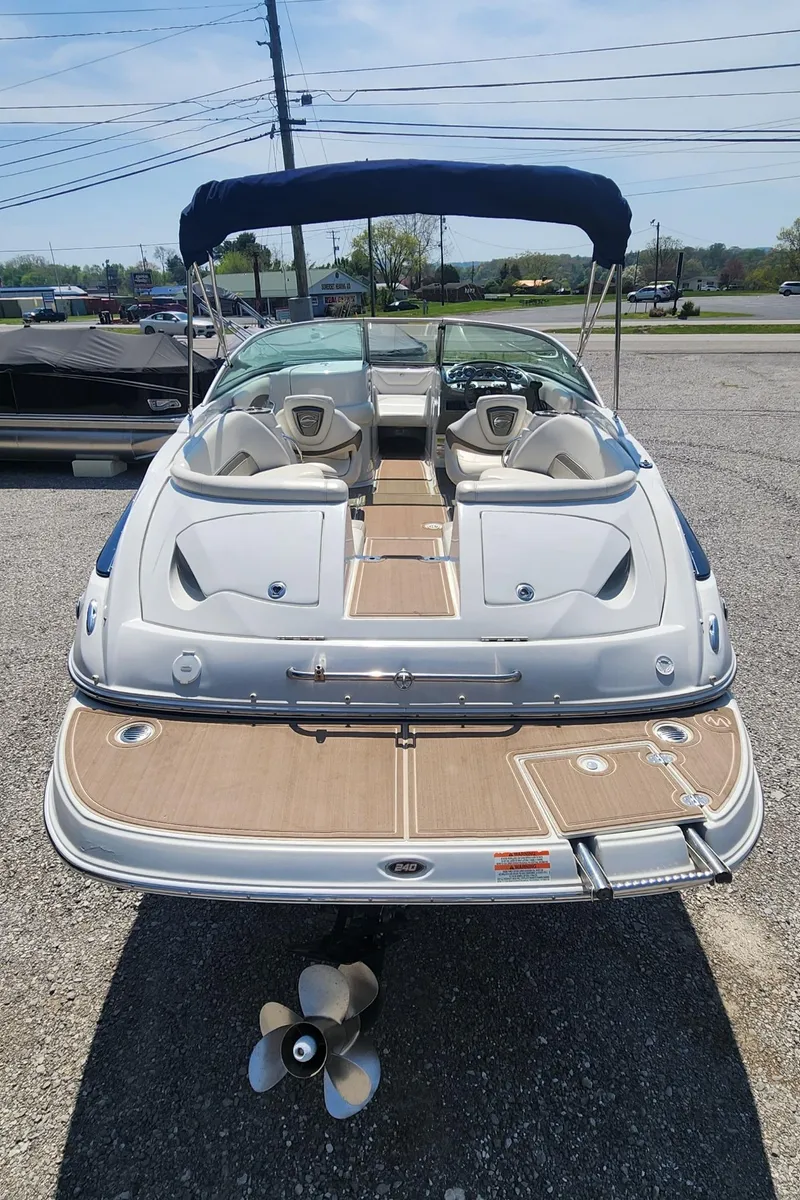 Slide: The Image of 2008 Crownline 240LS boat with blue canopy and spacious deck. - 4