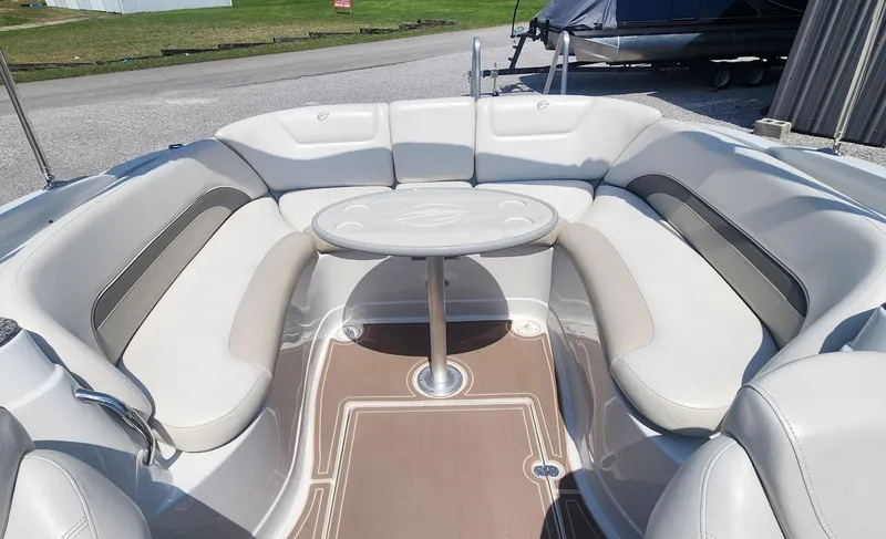 Slide: The Image of 2008 Crownline 240LS boat interior with circular seating and table. - 8