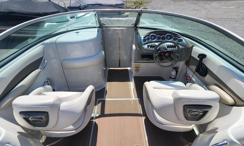 Slide: The Image of 2008 Crownline 240LS boat interior with dual seats and dashboard view. - 9