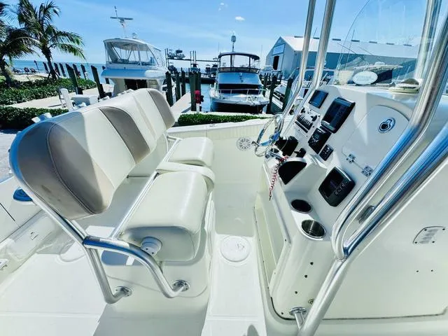 Slide: The Image of 2011 Hydra-Sports 2300CC boat interior with helm, seating, and marina view. - 12