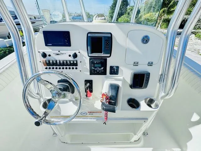 Slide: The Image of 2011 Hydra-Sports 2300CC boat console with steering wheel and navigation controls. - 13