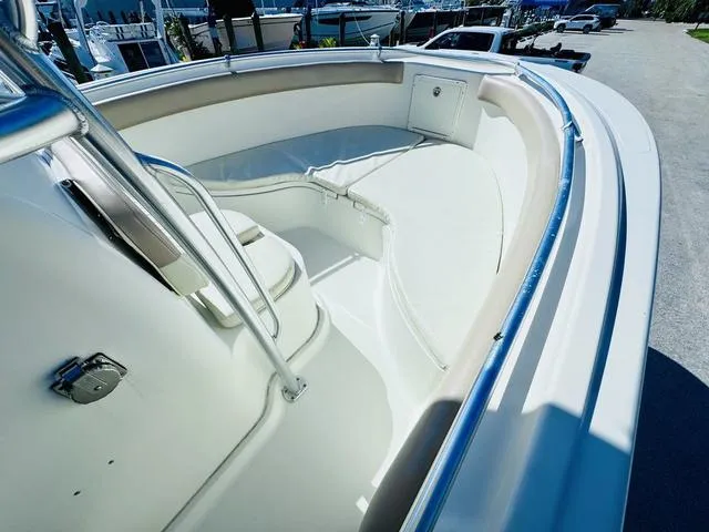 Slide: The Image of 2011 Hydra-Sports 2300CC boat interior with seating and railing, docked outdoors. - 16