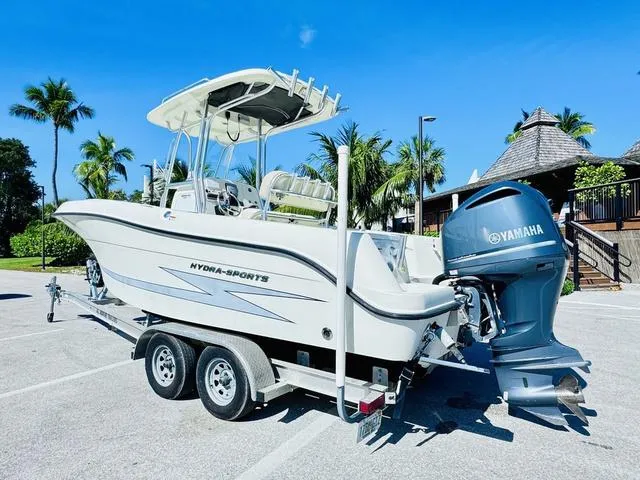 Slide: The Image of 2011 Hydra-Sports 2300CC boat on trailer with Yamaha outboard, parked in sunny tropical setting. - 3