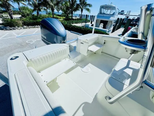 Slide: The Image of 2011 Hydra-Sports 2300CC boat interior with Yamaha engine, docked near palm trees. - 6