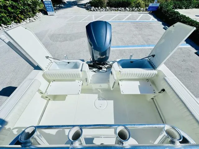 Slide: The Image of 2011 Hydra-Sports 2300CC boat interior with open storage compartments and powerful outboard motor. - 7