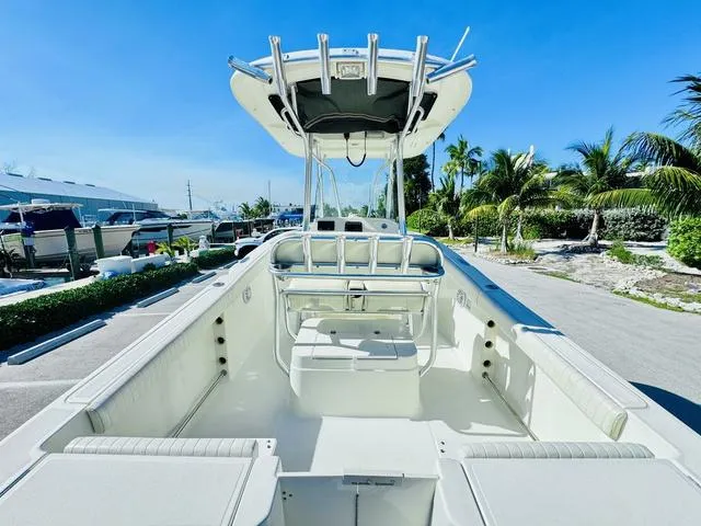 Slide: The Image of 2011 Hydra-Sports 2300CC boat with T-top, spacious deck, and seating, in a sunny marina. - 8