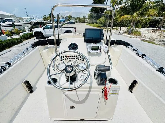 Slide: The Image of 2015 Carolina Skiff 198DLX boat console with steering wheel and navigation equipment. - 10