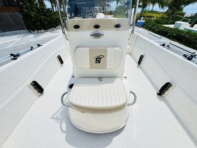 Slide: The Image of 2015 Carolina Skiff 198DLX boat interior with white seating and console. - 13