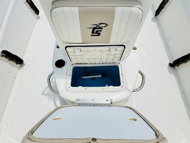 Slide: The Image of 2015 Carolina Skiff 198DLX boat interior with storage compartment and seating. - 14