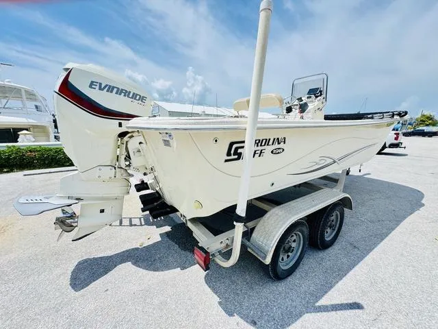 Slide: The Image of 2015 Carolina Skiff 198DLX boat on trailer with Evinrude outboard motor. - 16