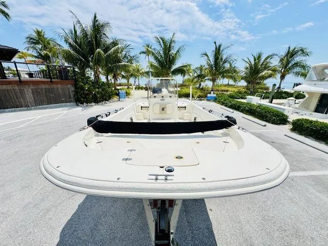 Slide: The Image of 2015 Carolina Skiff 198DLX boat parked near palm trees under a clear blue sky. - 20