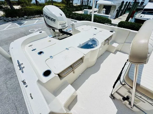 Slide: The Image of 2015 Carolina Skiff 198DLX boat with Evinrude 115 engine, docked at marina. - 5