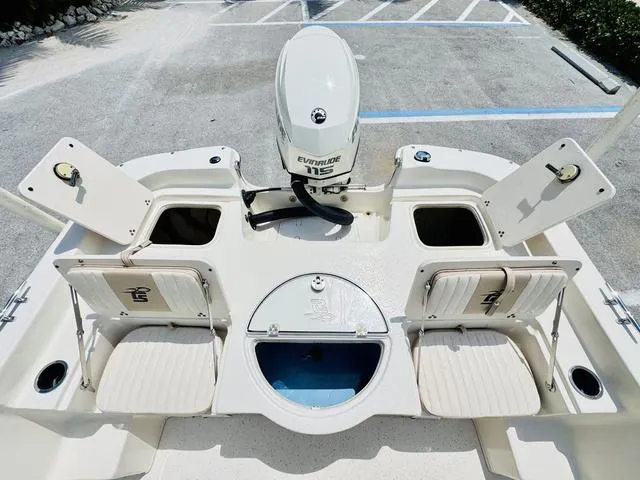 Slide: The Image of 2015 Carolina Skiff 198DLX boat interior with Evinrude 115 engine, storage compartments, and seating. - 6
