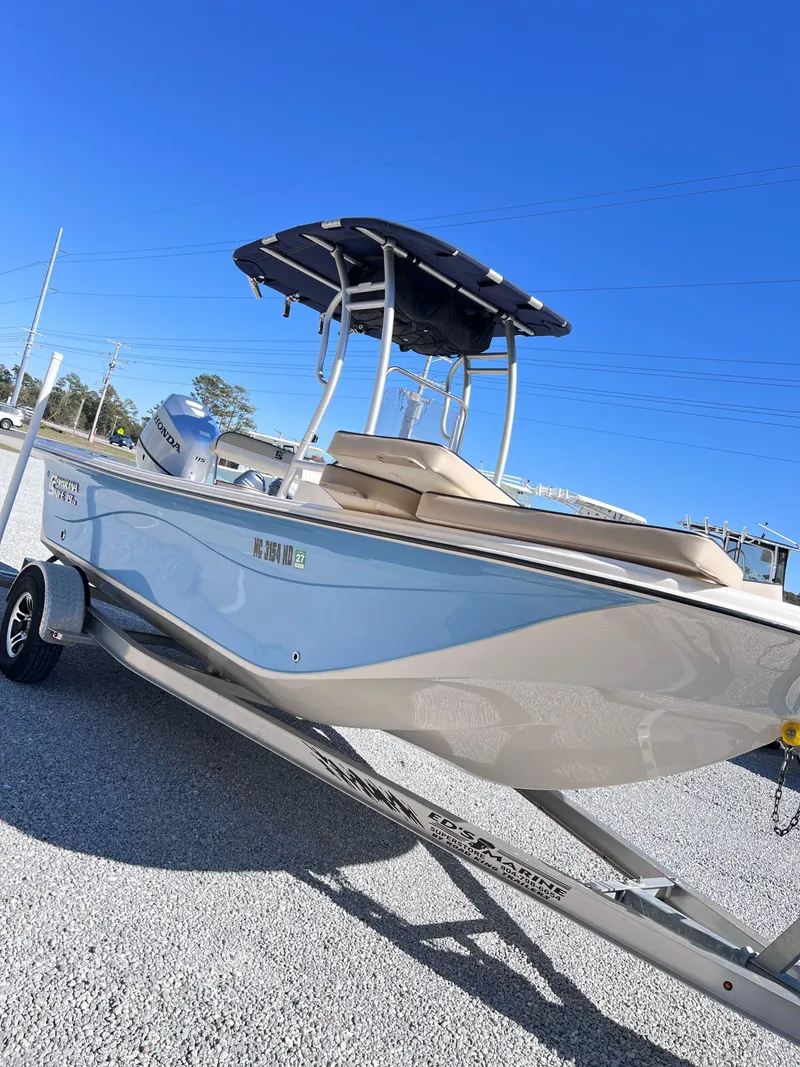 Slide: The Image of 2022 Carolina Skiff 19LS boat on trailer under clear blue sky. - 2
