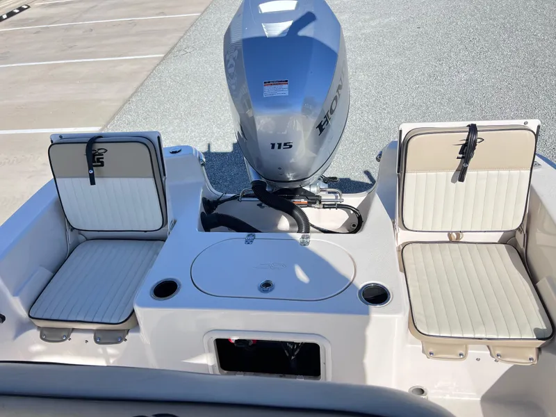 Slide: The Image of 2022 Carolina Skiff 19LS boat interior with seating and Honda 115 outboard motor. - 6