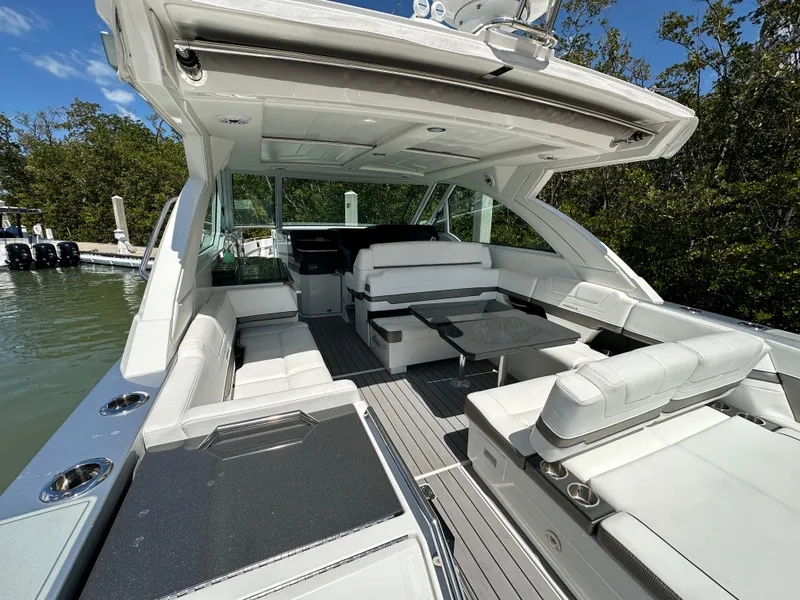 Slide: The Image of 2022 Formula 380 Super Sport Crossover boat with spacious seating and sleek design. - 15