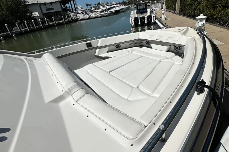Slide: The Image of 2022 Formula 380 Super Sport Crossover boat with spacious white seating area at marina. - 17