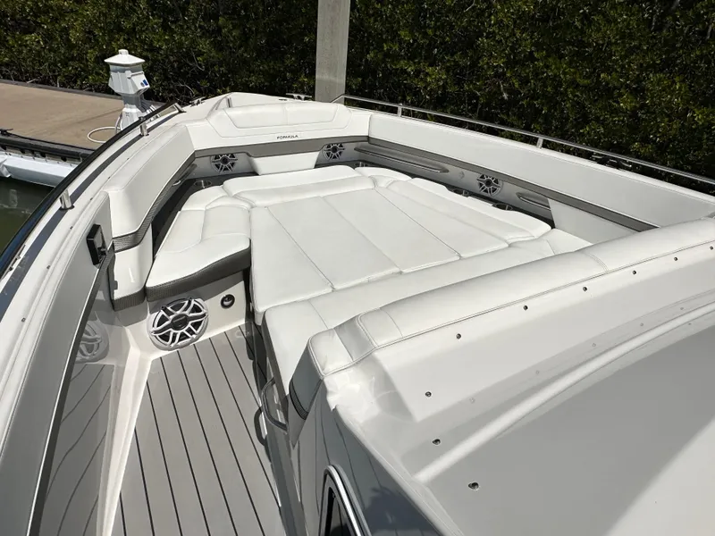 Slide: The Image of 2022 Formula 380 Super Sport Crossover boat with spacious white seating area. - 18
