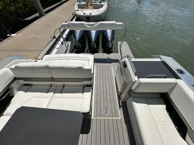 Slide: The Image of 2022 Formula 380 Super Sport Crossover boat with spacious seating and triple outboard engines. - 20