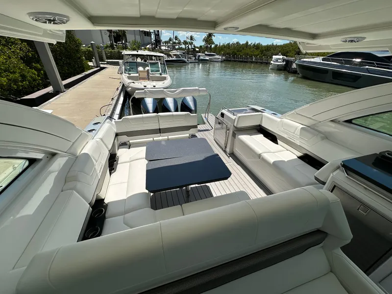 Slide: The Image of 2022 Formula 380 Super Sport Crossover boat interior with luxurious seating and waterfront view. - 23