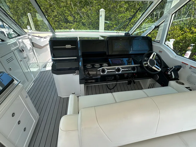 Slide: The Image of 2022 Formula 380 Super Sport Crossover cockpit with modern controls and luxurious seating. - 24