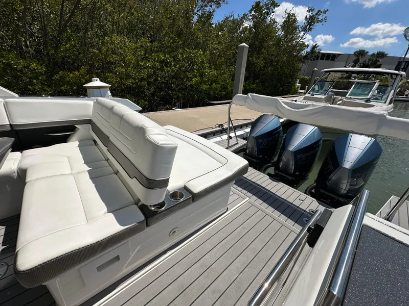 Slide: The Image of 2022 Formula 380 Super Sport Crossover boat with luxurious seating and triple outboard engines. - 28