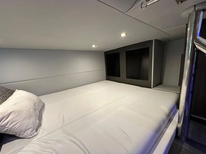 Slide: The Image of 2022 Formula 380 Super Sport Crossover cabin interior with modern bedding and ambient lighting. - 35