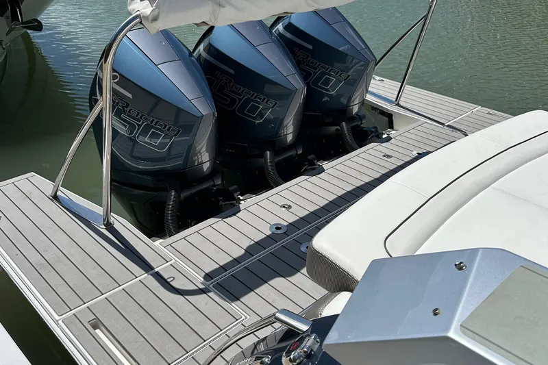 Slide: The Image of 2022 Formula 380 Super Sport Crossover with triple outboard engines on a sleek deck. - 4