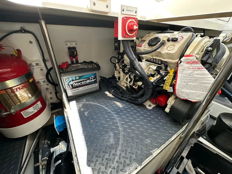 Slide: The Image of Engine compartment of 2022 Formula 380 Super Sport Crossover with battery and fire extinguisher. - 40
