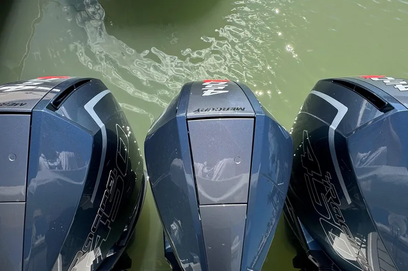 Slide: The Image of Three powerful outboard motors on a 2022 Formula 380 Super Sport Crossover boat. - 7