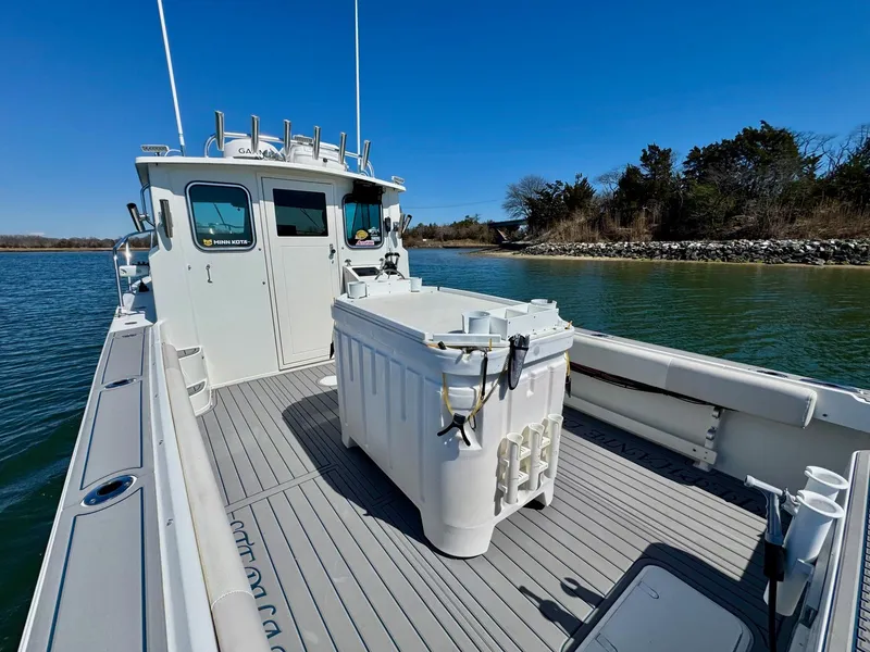 Slide: The Image of 2016 Parker 2820 XLD Sport Cabin boat on calm water, clear sky background. - 14