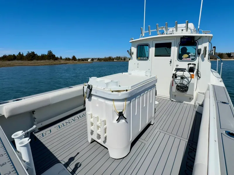 Slide: The Image of 2016 Parker 2820 XLD Sport Cabin boat on calm water, featuring spacious deck and cabin. - 15