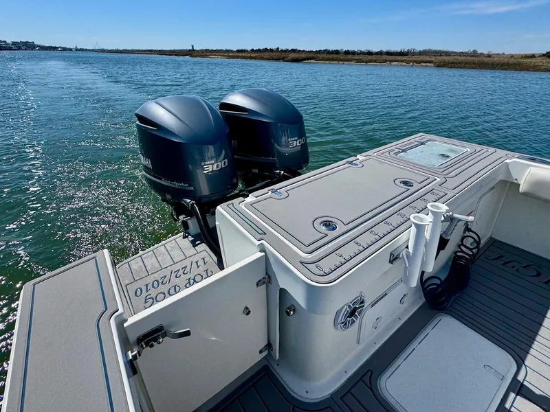 Slide: The Image of 2016 Parker 2820 XLD Sport Cabin with twin Yamaha 300 engines on a calm waterway. - 16