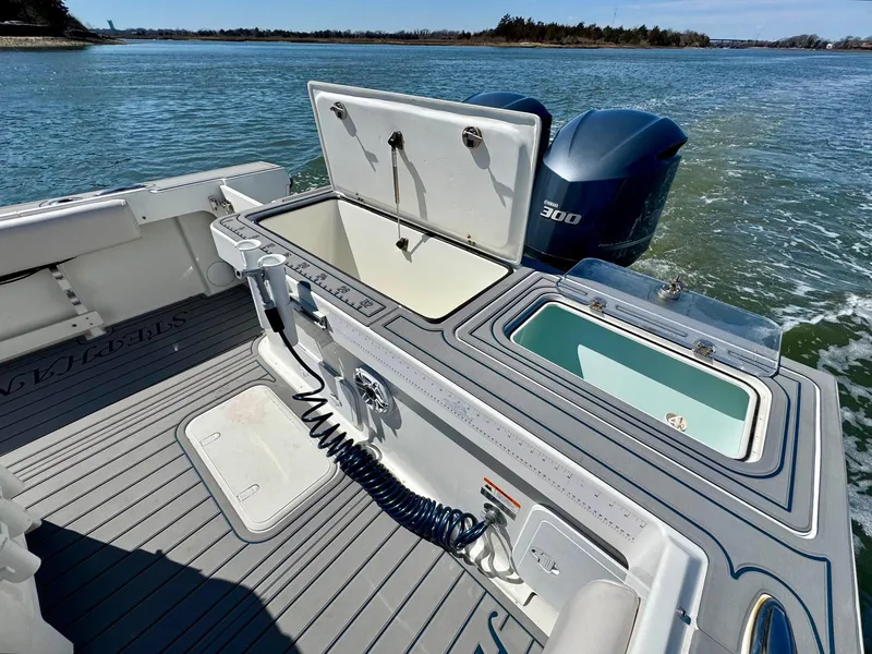 Slide: The Image of 2016 Parker 2820 XLD Sport Cabin boat with open storage compartments and Yamaha 300 engine. - 17