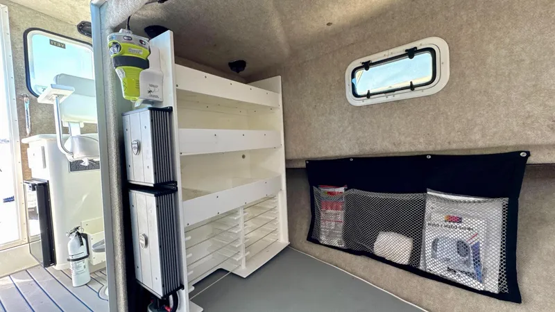 Slide: The Image of Interior of 2016 Parker 2820 XLD Sport Cabin with storage shelves and netted pockets. - 19