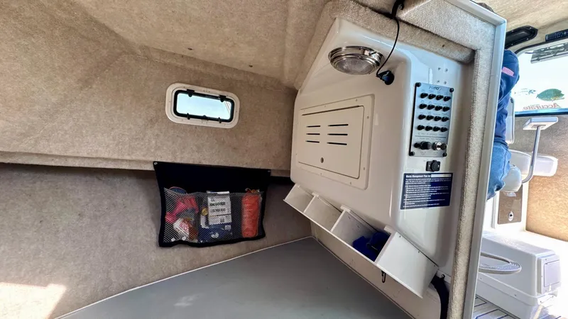 Slide: The Image of Interior of a 2016 Parker 2820 XLD Sport Cabin with storage compartments and control panel. - 20