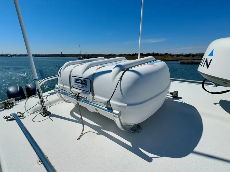 Slide: The Image of 2016 Parker 2820 XLD Sport Cabin with life raft on deck, scenic water view. - 22