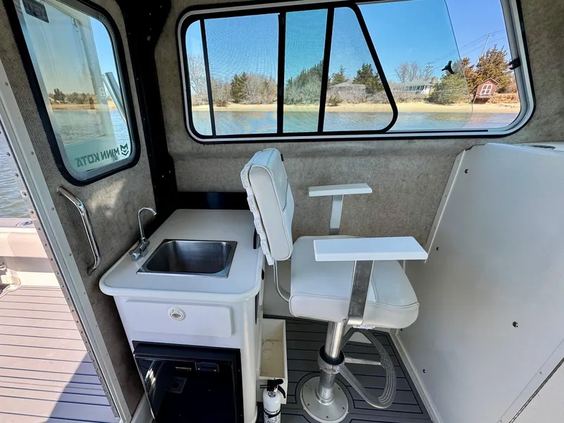 Slide: The Image of Interior of 2016 Parker 2820 XLD Sport Cabin with sink and swivel chair. - 7