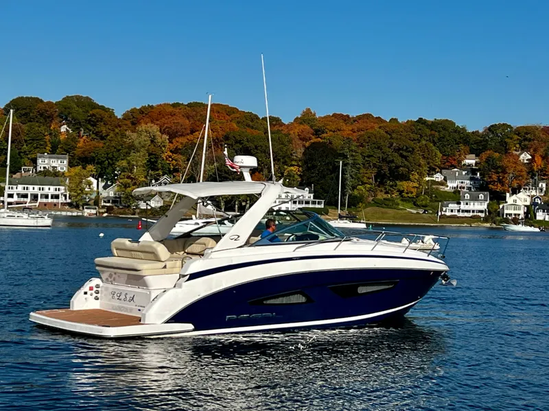 Slide: The Image of 2018 Regal 33 Express boat cruising on a scenic lake with autumn foliage. - 1