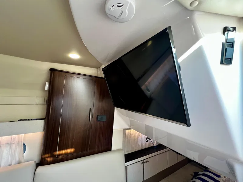 Slide: The Image of Interior of 2018 Regal 33 Express yacht with TV and wooden cabinetry. - 11